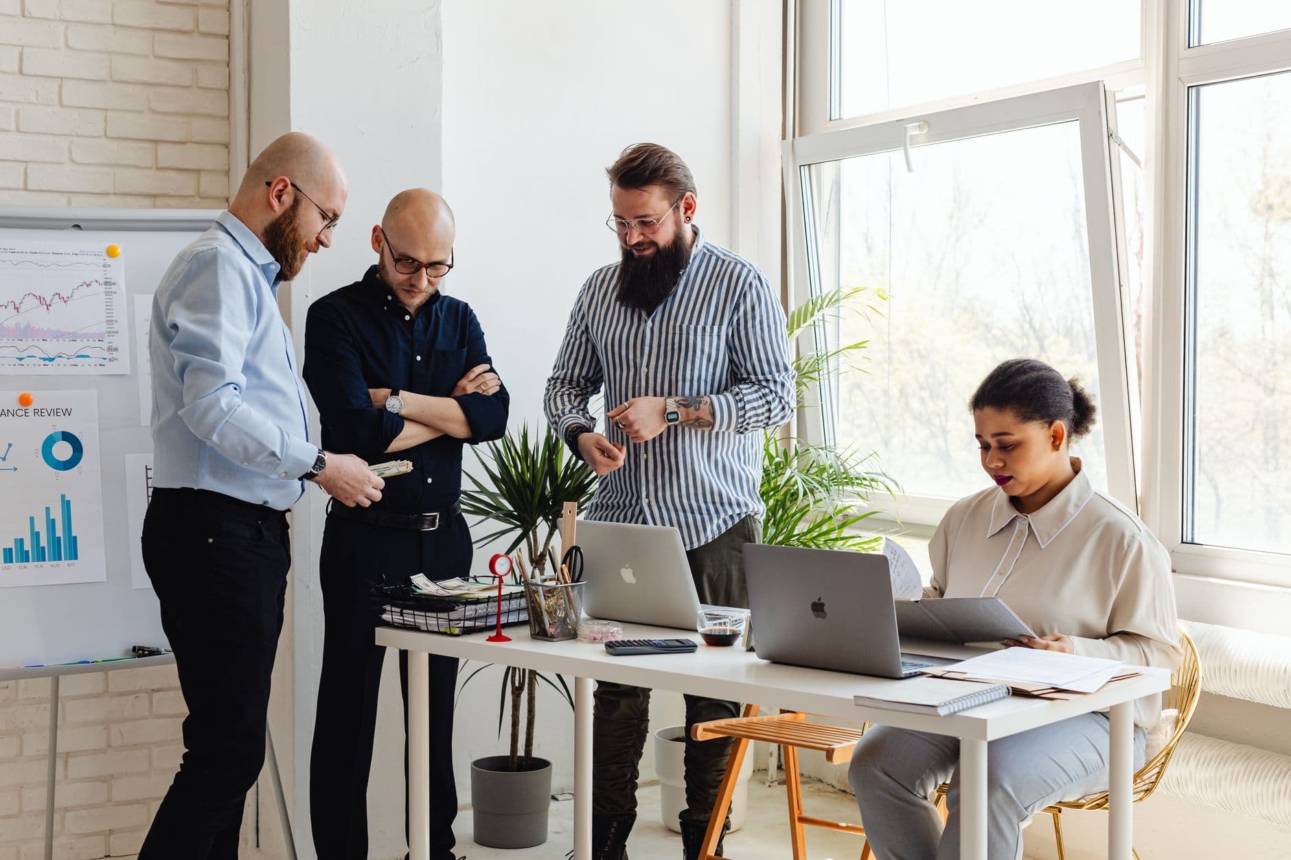 Business professionals collaborating on project in bright modern office space.
