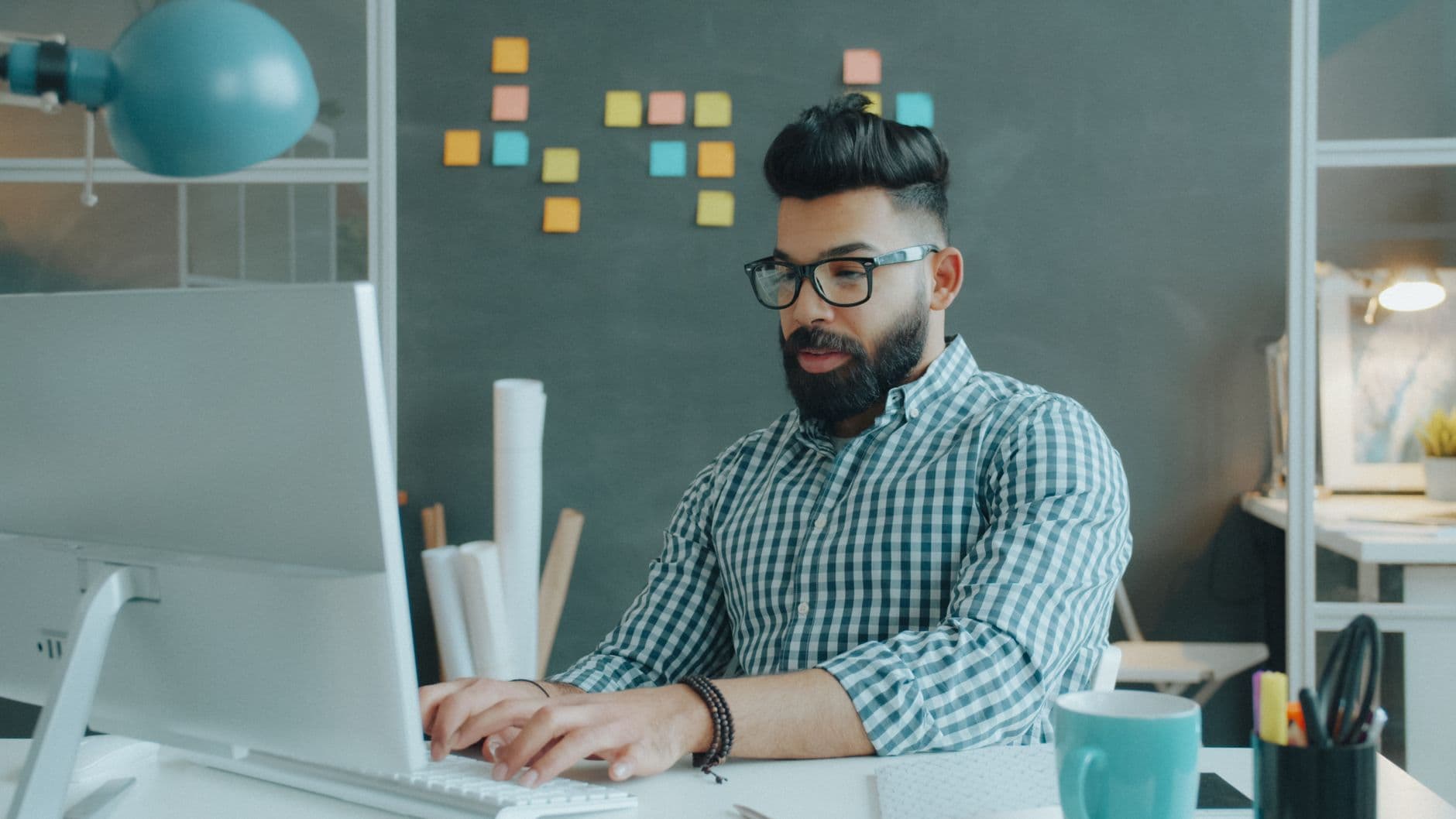 Businessman working at his computer in an innovative, modern office setting.